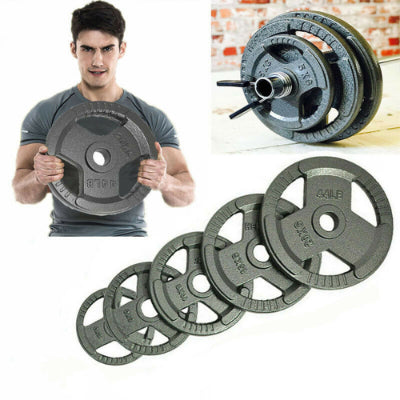 A weightlifter preparing for a set, adjusting Olympic weight plates on a barbell in a bright, spacious gym