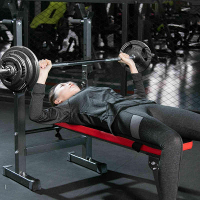 A set of shiny Olympic weight plates stacked neatly on a gym floor, showcasing various weights labeled clearly